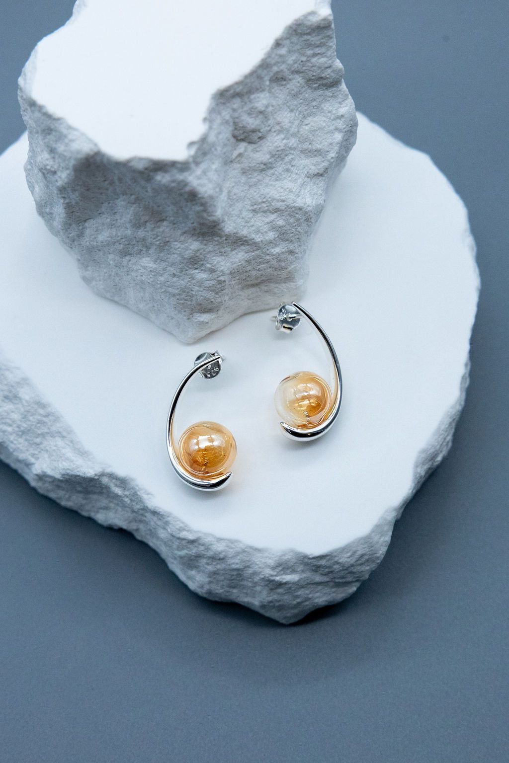 silver and gold curve globe stud